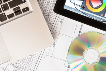 Work on the project, a tablet and a laptop on the table with a o