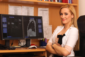 Portrait of a smiling female doctor sitting at work desk