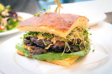 Healthy vegetarian sandwich with sprouts, lettus, portobella, gr