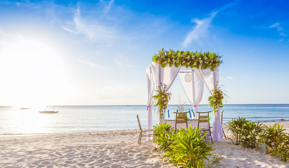 wedding arch and set up on beach, tropical outdoor wedding caban