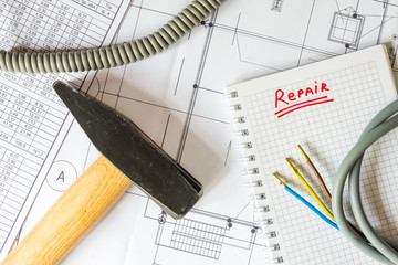 Home repair, a hammer with a wires on the table