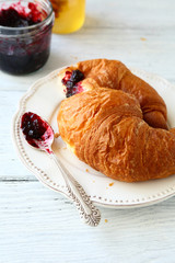 Freshly baked croissant on a white plate