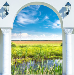 Fototapeta premium open door with a view of green meadow illuminated by bright suns