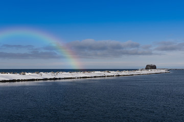 winter landscape with sea, snow and rock