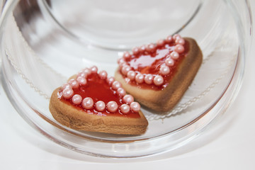 Two romantic heart shaped homemade Valentine cookies in a bowl o