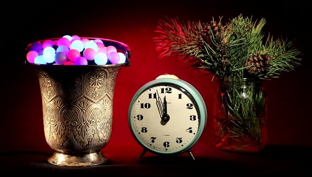 New year. Vintage clock, silver vase, flashing lights and tree.