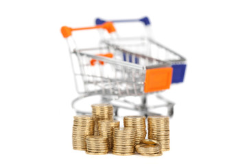 coins in a column on the background shopping carts. focus on coi