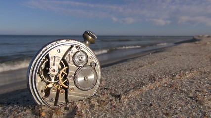 old pocket clock on ocean beach sand - Powered by Adobe
