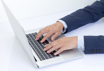 Fototapeta na wymiar Businessman hands typing on laptop computer