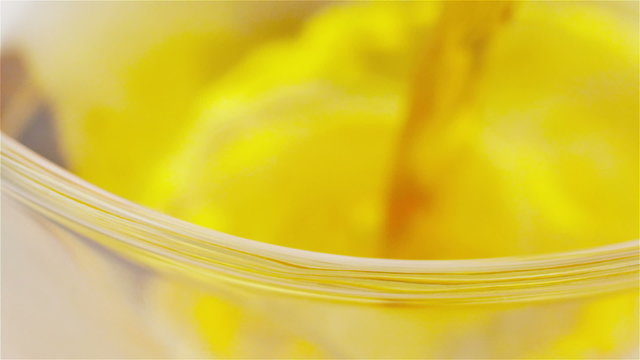 Close up focus pull of tea being poured into a glass cup