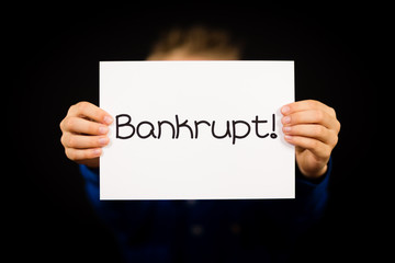 Child holding Bankrupt sign