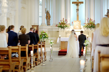 Fototapeta na wymiar Bride and groom at the church during a wedding