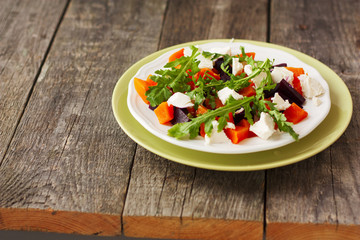 salad of roasted beets and pumpkin with feta cheese and arugula