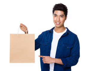 Man finger point to shopping bag