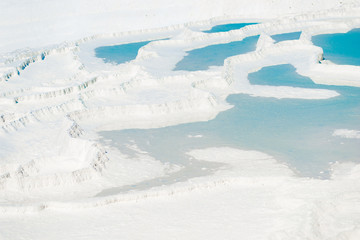beautiful turquoise water on snowy mountain in Pamukkale