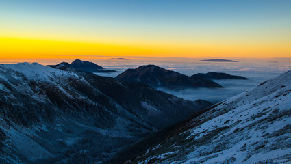 Fototapeta na wymiar Sunset in mountains above clouds - Tatra Mountains in Poland