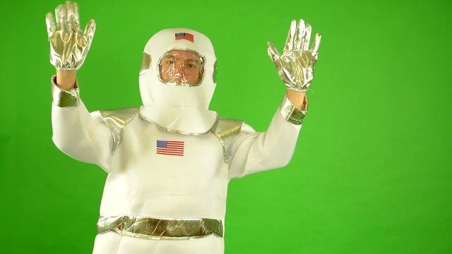 astronaut waves with both hands - green screen