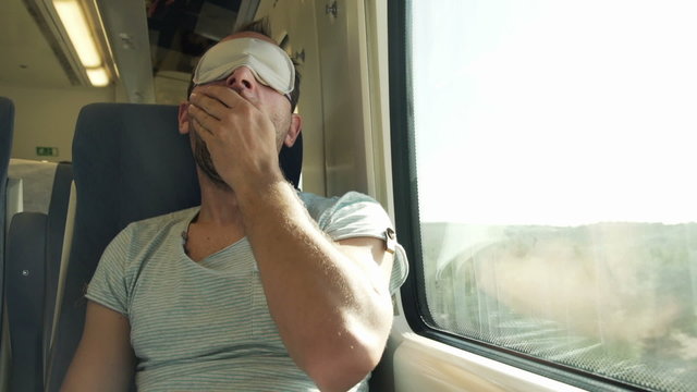 Man With Sleeping Eye Mask Wake Up From Nap On A Train