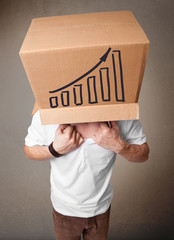 Young man gesturing with a cardboard box on his head with diagra