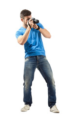 Standing man taking photo with dslr isolated