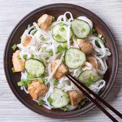 rice noodles with chicken and cucumbers close-up top view