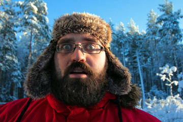 Winter portrait of Bearded man in russian fur hat