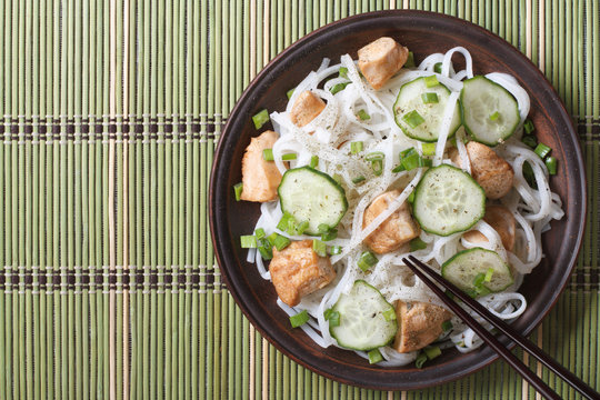 Japanese rice noodles with chicken and cucumbers top view