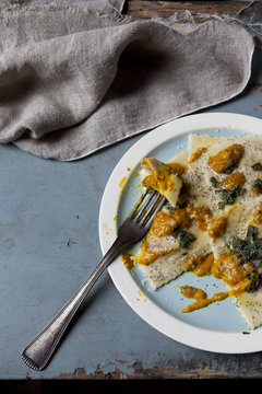 homemade stuffed with pumpkin ravioli on plate on rustic table