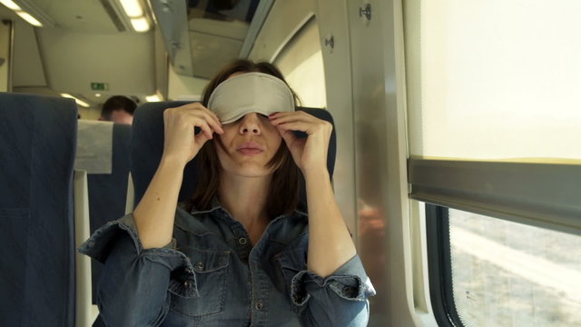 Young Woman With Sleeping Eye Mask On A Train 