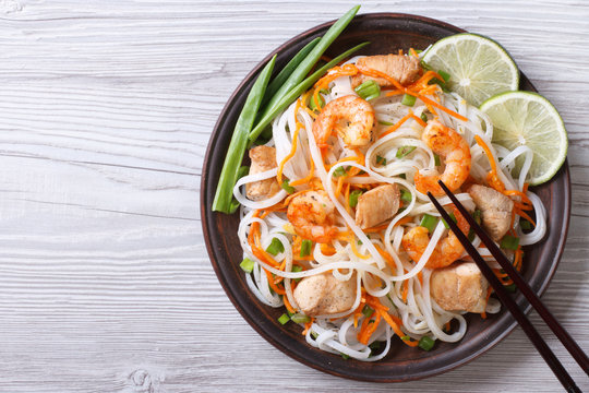 rice noodles with chicken, shrimp and vegetables top view