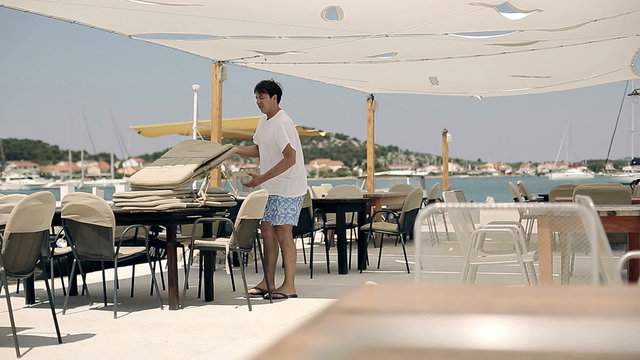 Owner of the restaurant and prepares restaurant tables