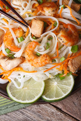 rice noodles with shrimp and chicken, vegetables vertical