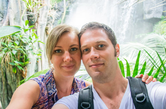 Attractive couple doing selfie in jungle.