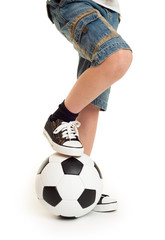 feet shod in sneakers and soccer ball