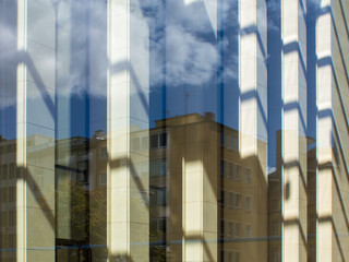 Fototapeta na wymiar Reflection in the glass facade of a skyscraper in Frankfurt, Ger