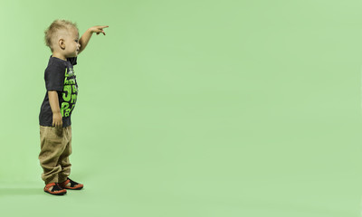 Fashionable little blond boy pointing