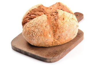 loaf of bread on a cutting board isolated on white