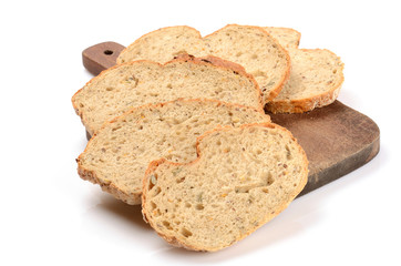 sliced loaf of bread on a cutting board isolated on white