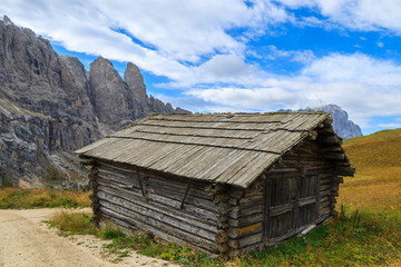 Wooden hut at Passo Gardena in autumn, Dolomites Mountains