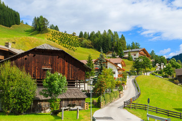 Street in Colfosco alpine village, Dolomites Mountains, Italy - obrazy, fototapety, plakaty