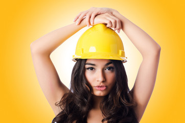 Young woman with hellow hard hat on white