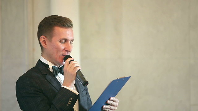 entertainer leads event speaks into the microphone