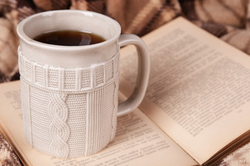 Cup of tea with book on table close-up