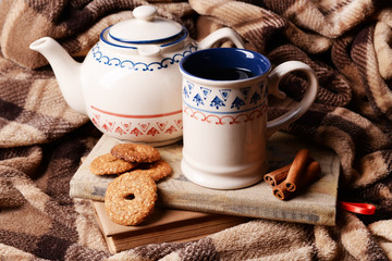 Cup of tea with cookies on table close-up