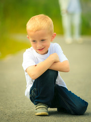 Fototapeta premium Little thoughtful boy child portrait outdoor