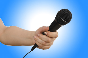 Hand with microphone on white
