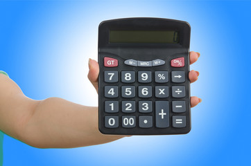 Hand holding calculator on white