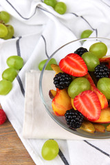 fresh tasty fruit salad on wooden table