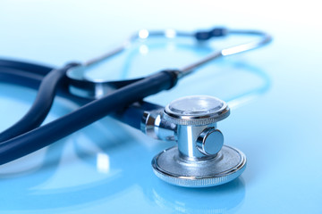 Stethoscope on light blue background