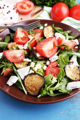 Eggplant salad with tomatoes, arugula and feta cheese,